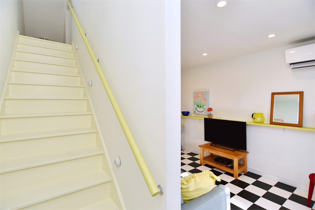 View of the stairs next to living area