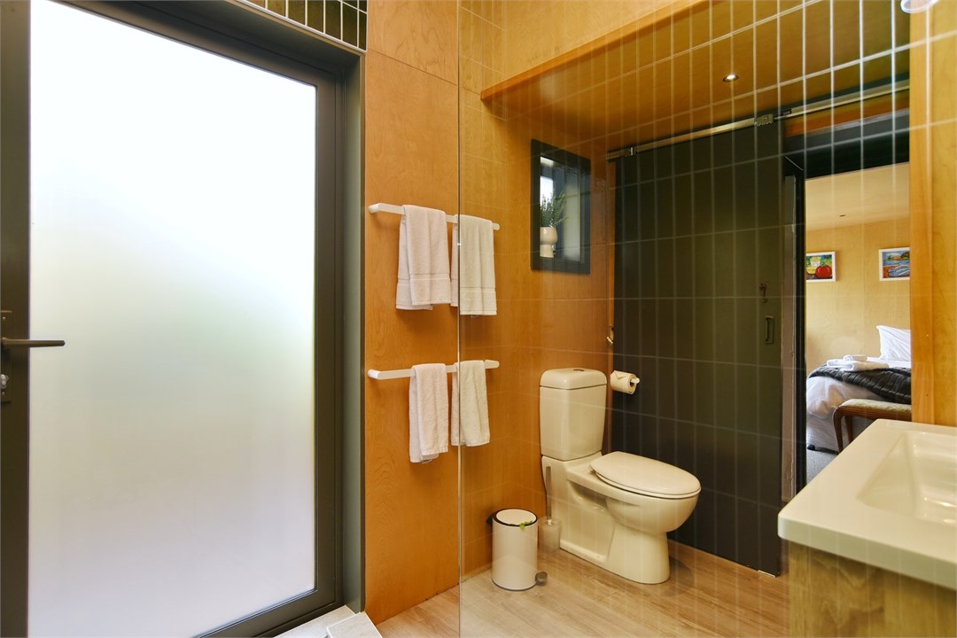 Bathroom has a shower and a toilet