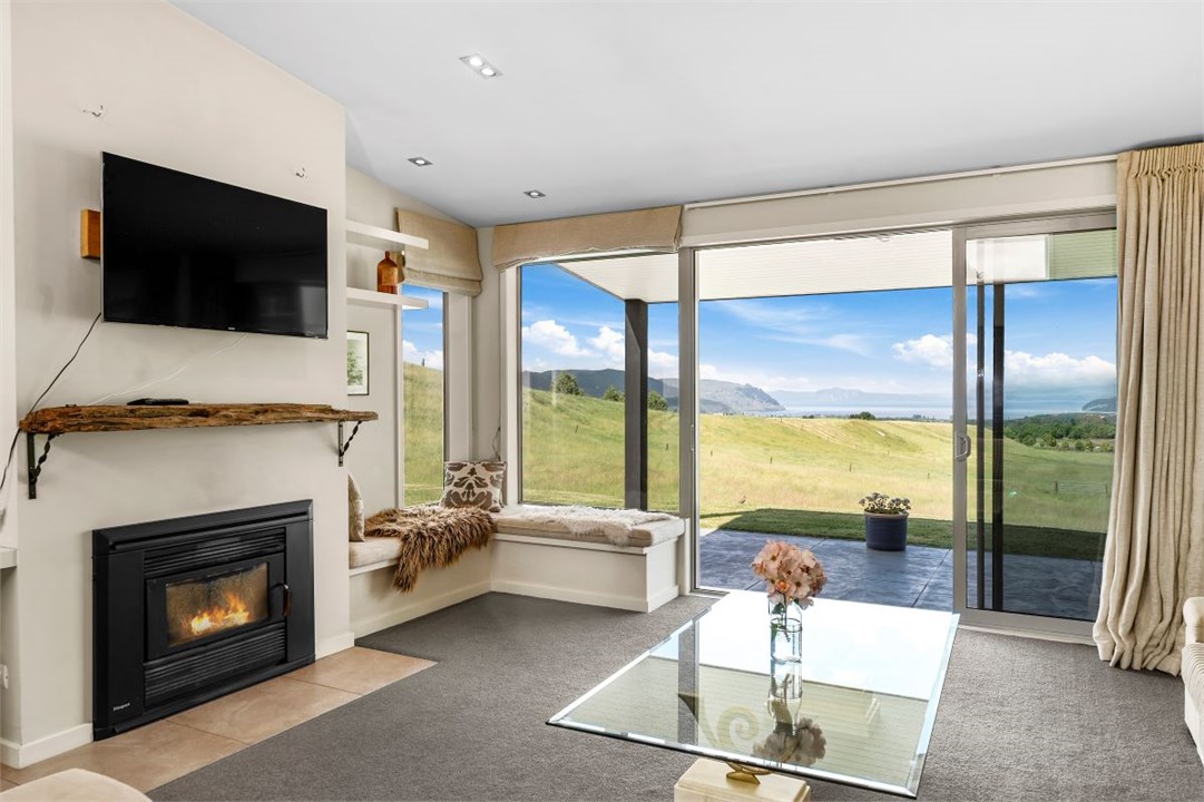Living room with a view, wood burner and smart TV.