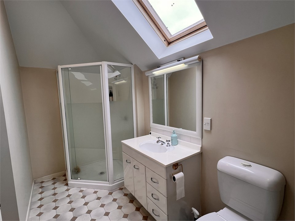 Bathroom 2 has a shower, bathtub and a toilet