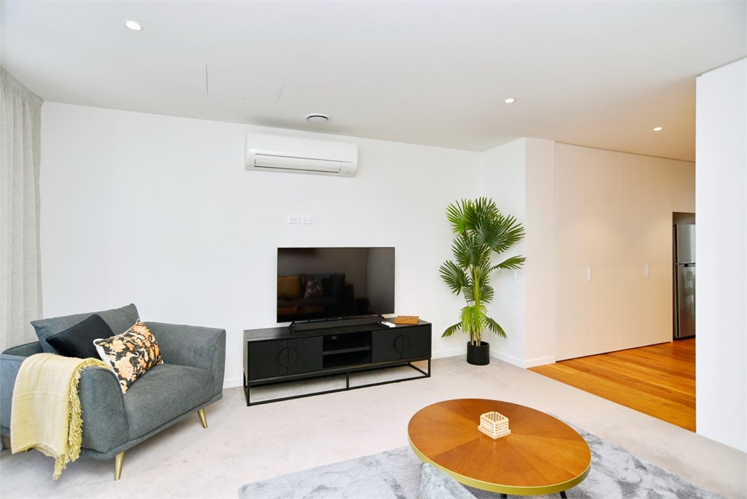 Living room has a TV and seating areas