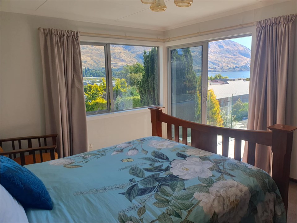 Master bedroom view out to lake and deck