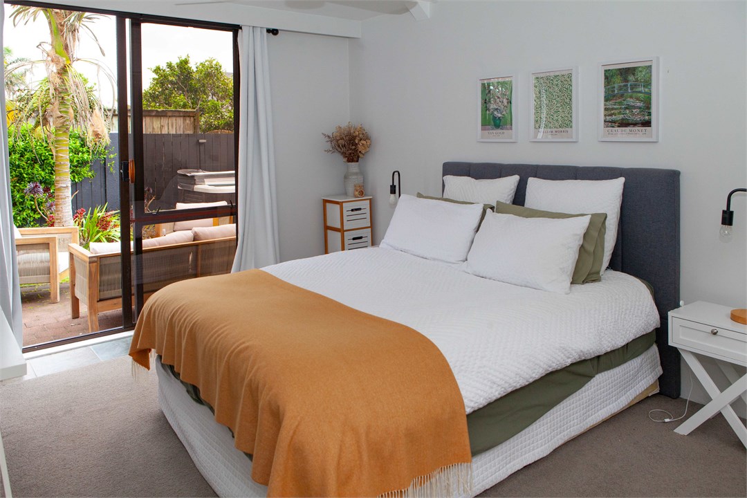 Second bedroom with queen size bed and ceiling fan