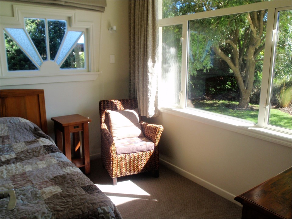 Our sunny front bedroom has a long single bed