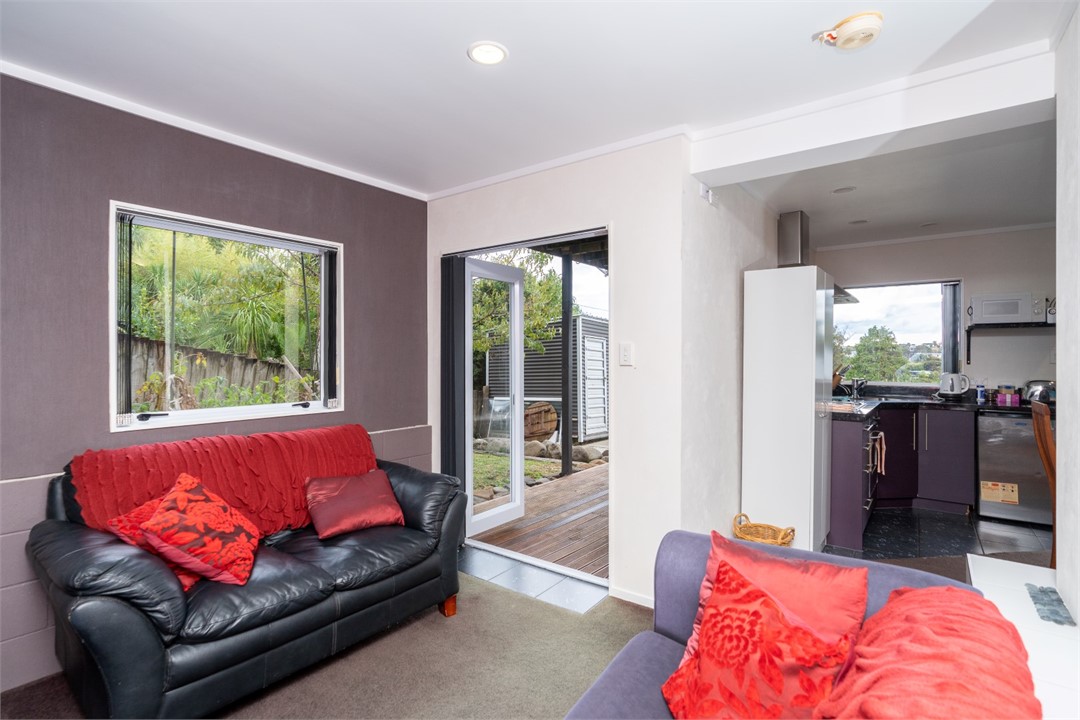Living room with seating areas and a TV
