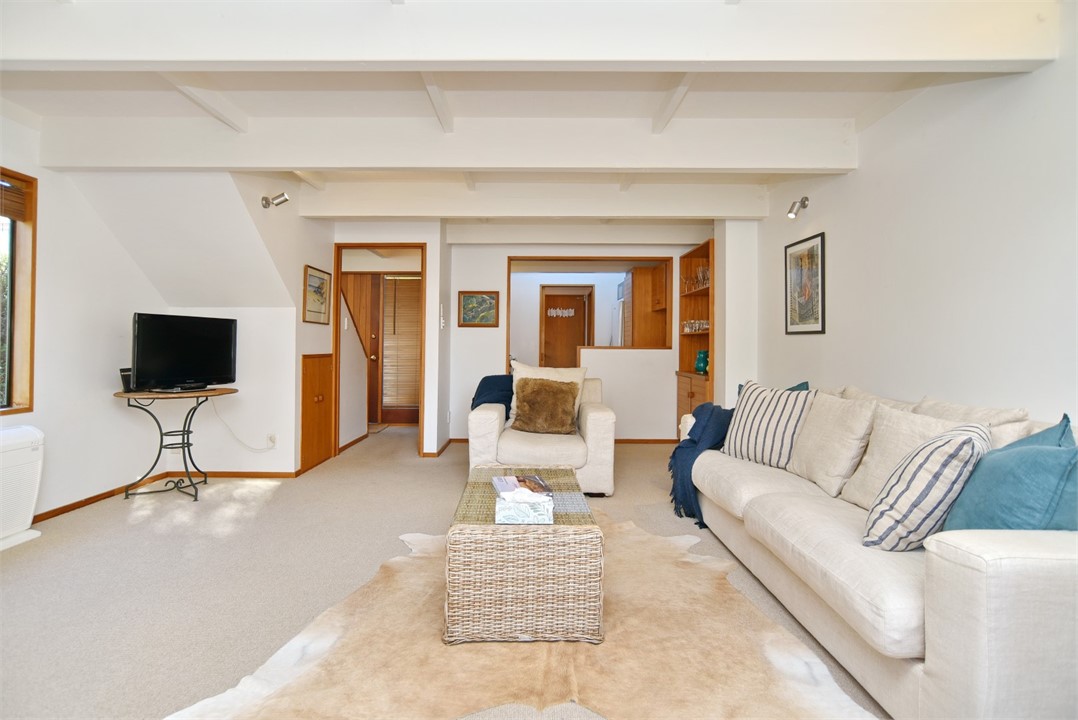 Living room with a seating area and a TV