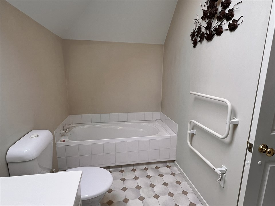 Bathroom 2 has a shower, bathtub and a toilet