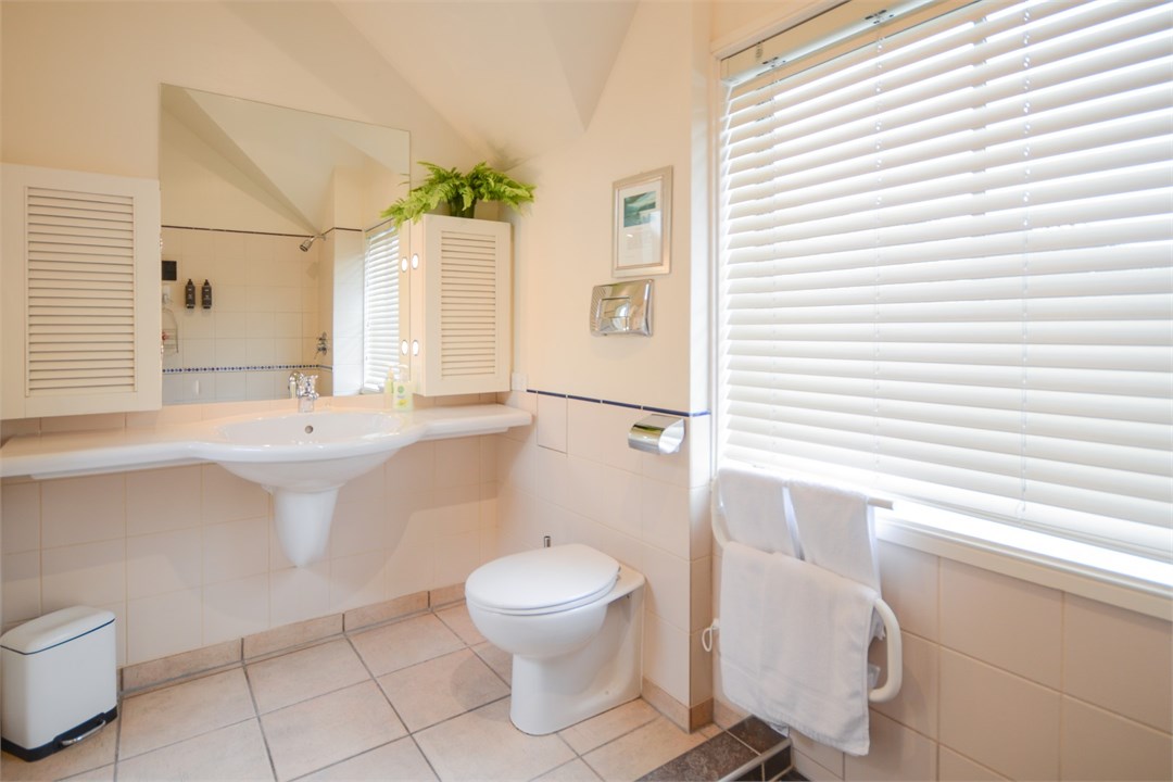 Bathroom has a shower and a toilet