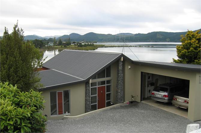 Main entrance with water feature & double garage 