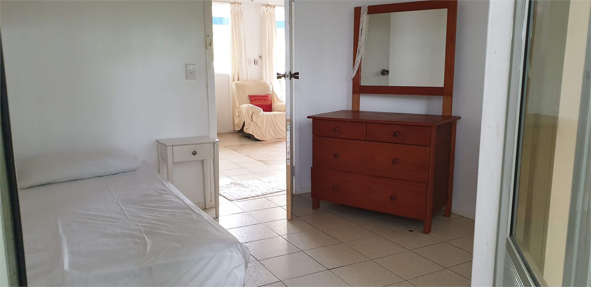 Smaller bedroom through to living room