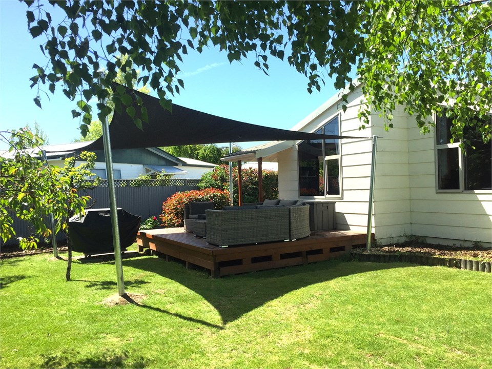 BBQ and deck with seating in the back yard