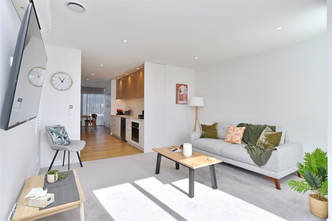 Living room has a TV and seating areas