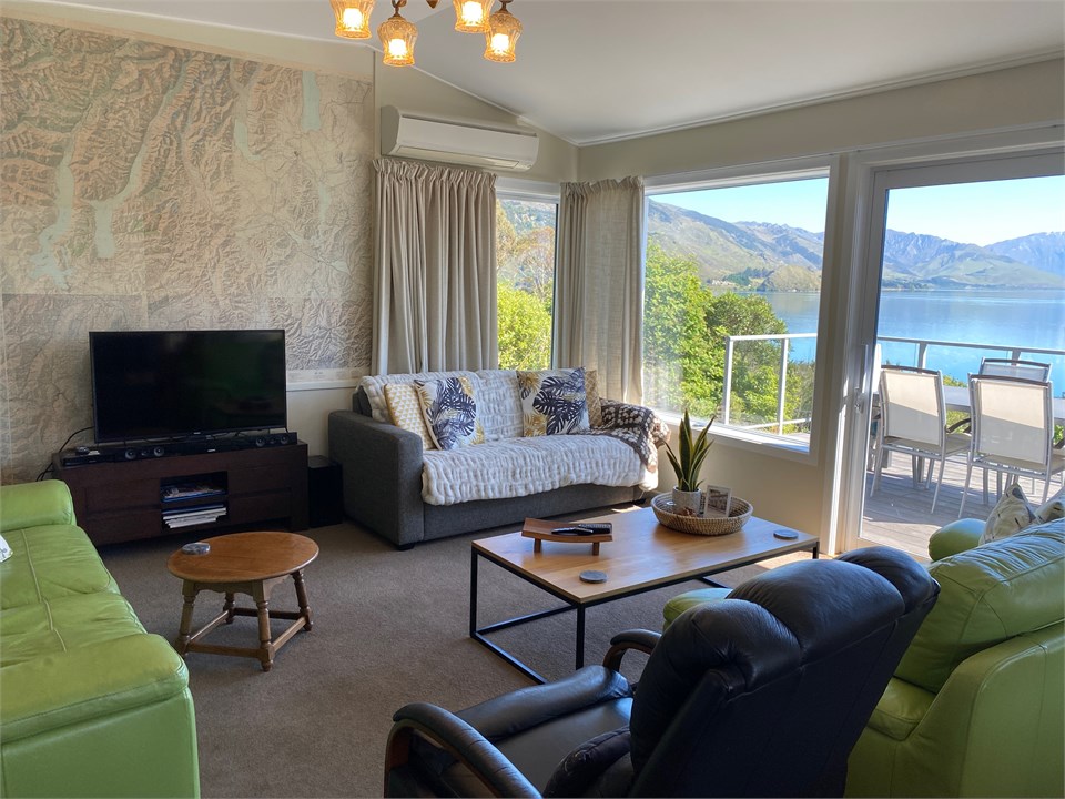 Lounge with TV with stunning views and deck