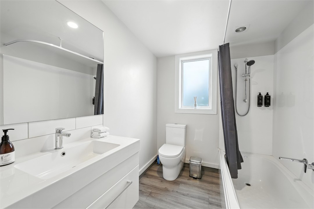 Bathroom 2 has a bath, shower and a toilet