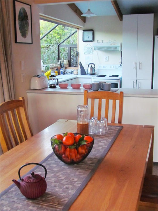 Dining looking into fully equipped kitchen