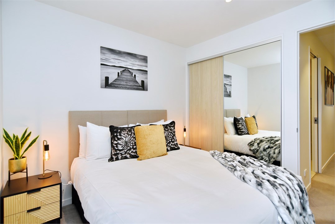 Bedroom 2 has a Queen bed and a TV