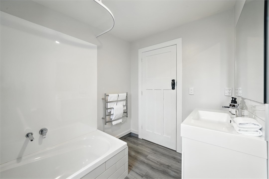 Bathroom 2 has a bath, shower and a toilet