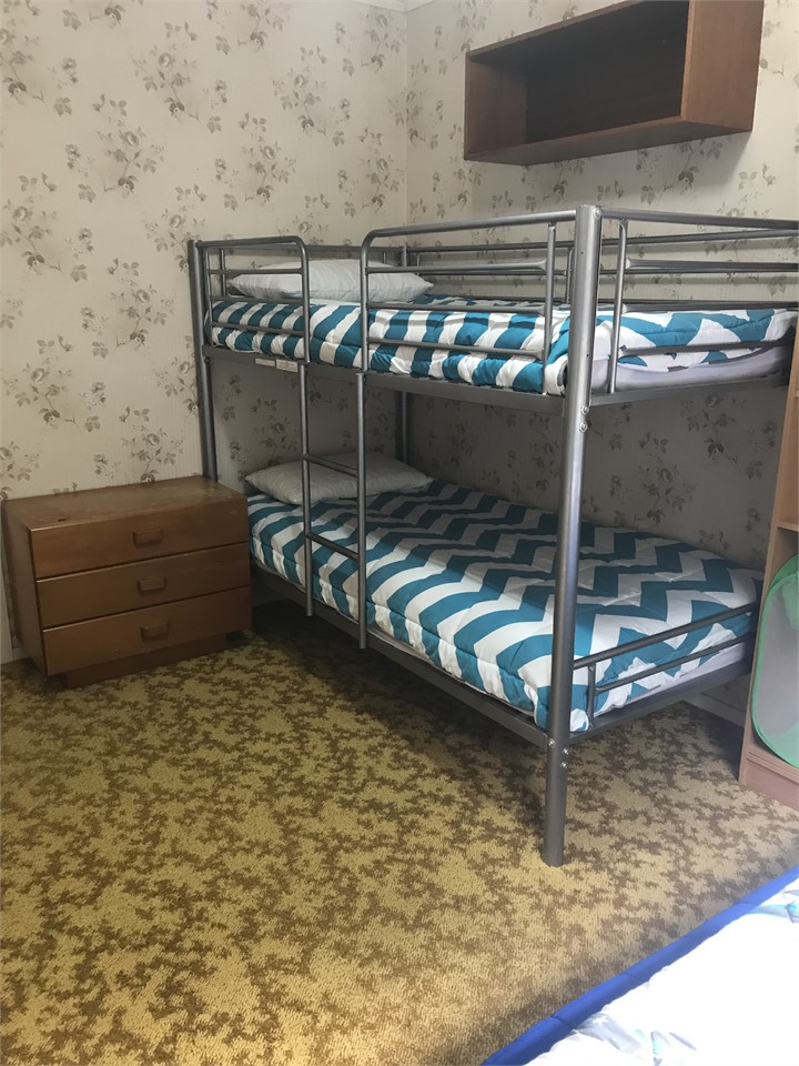 Dog bed provided is under the lower bunk.