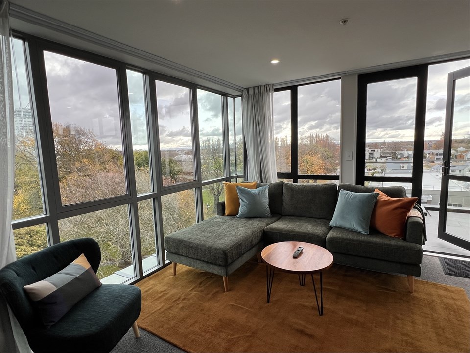 Living room has seating areas and a TV