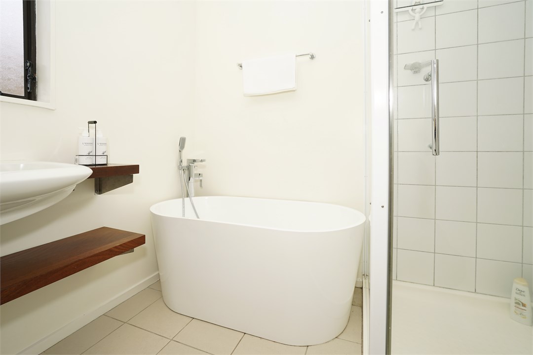 Bathroom has a shower and a bathtub