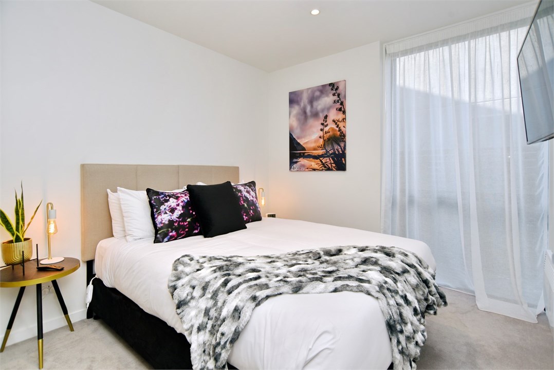 Bedroom 1 has a Queen bed and a TV