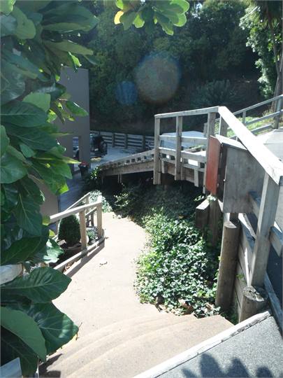 Drive ramp on the right and steps to front door.