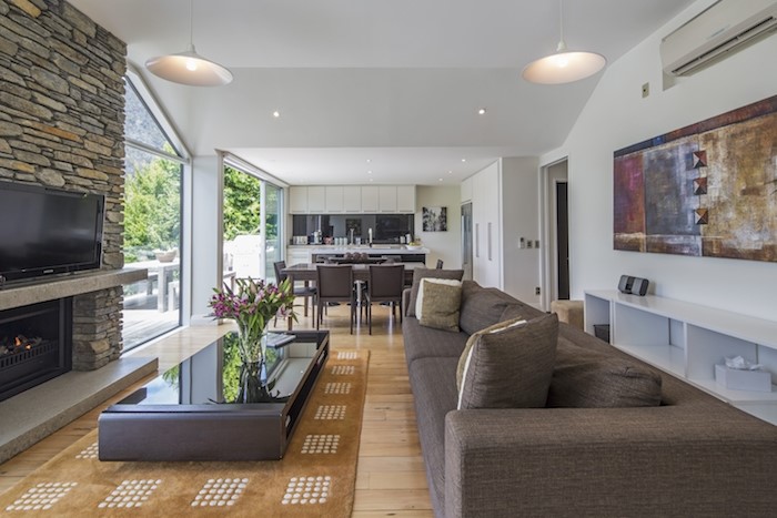 Living area leading into kitchen with a gas firepl