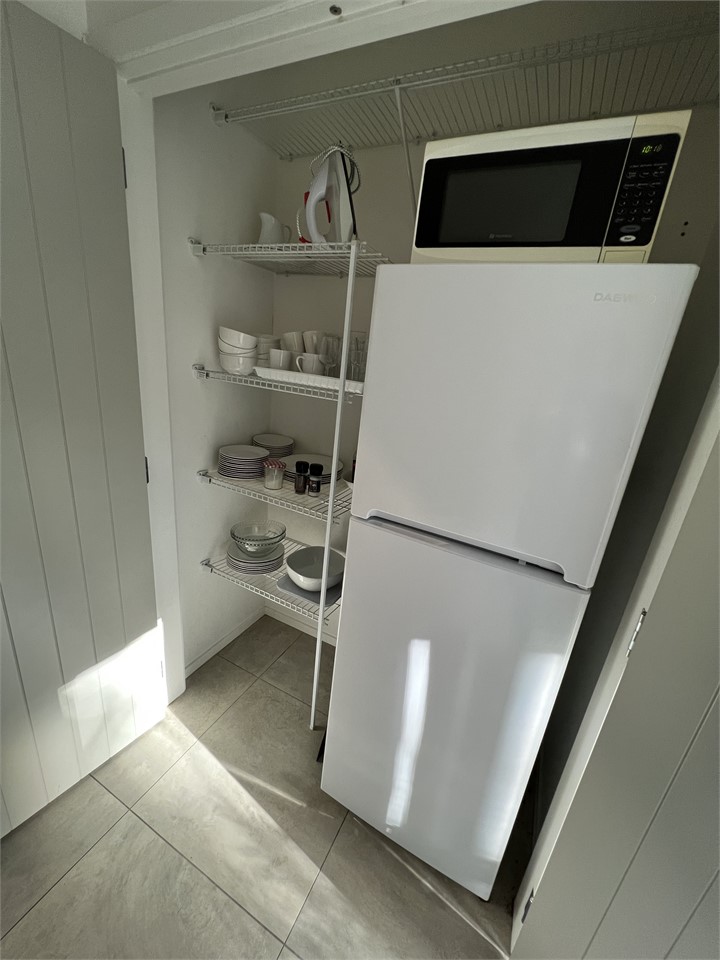 Large pantry with fridge freezer, microwave etc.