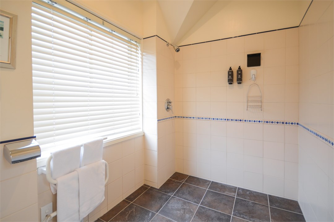 Bathroom has a shower and a toilet