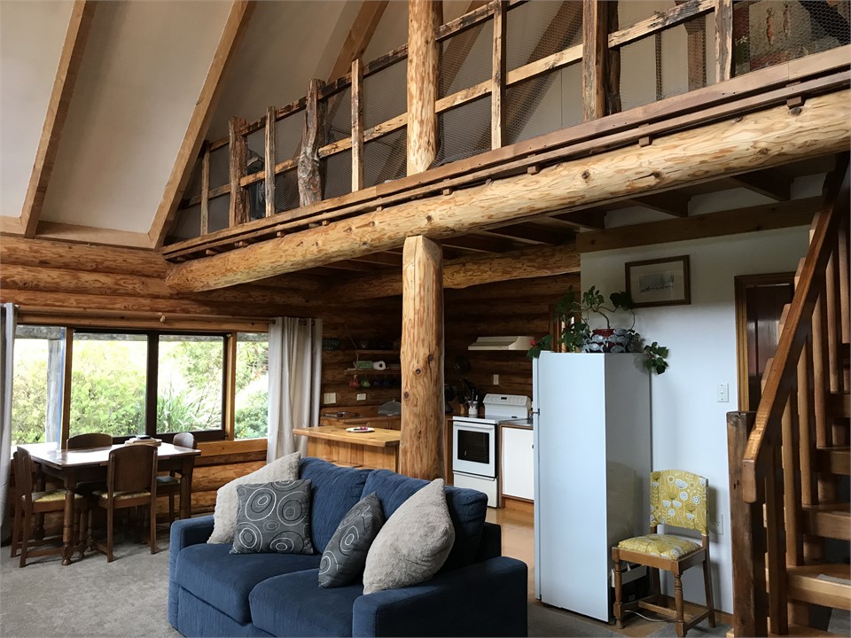 Living area looking up to mezzanine bedroom