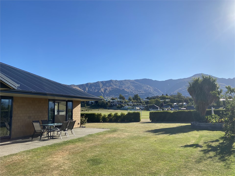 Large garden backing onto sports fields with socce