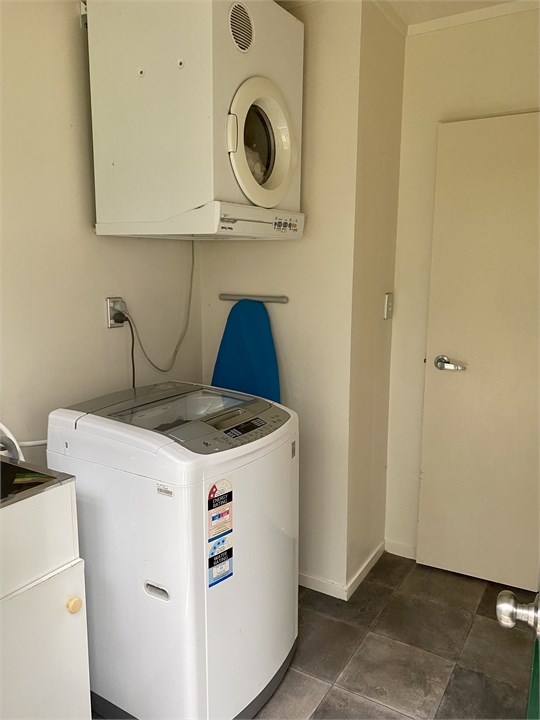 Laundry with top loading washing machine and dryer