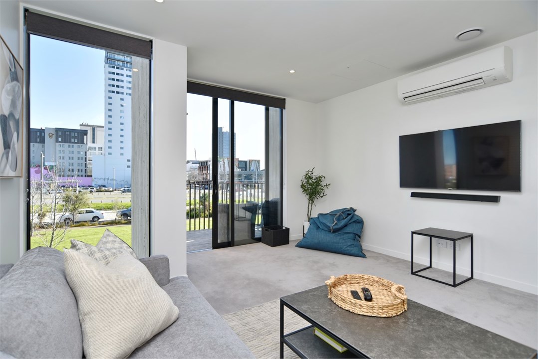 Living room has a TV and seating areas