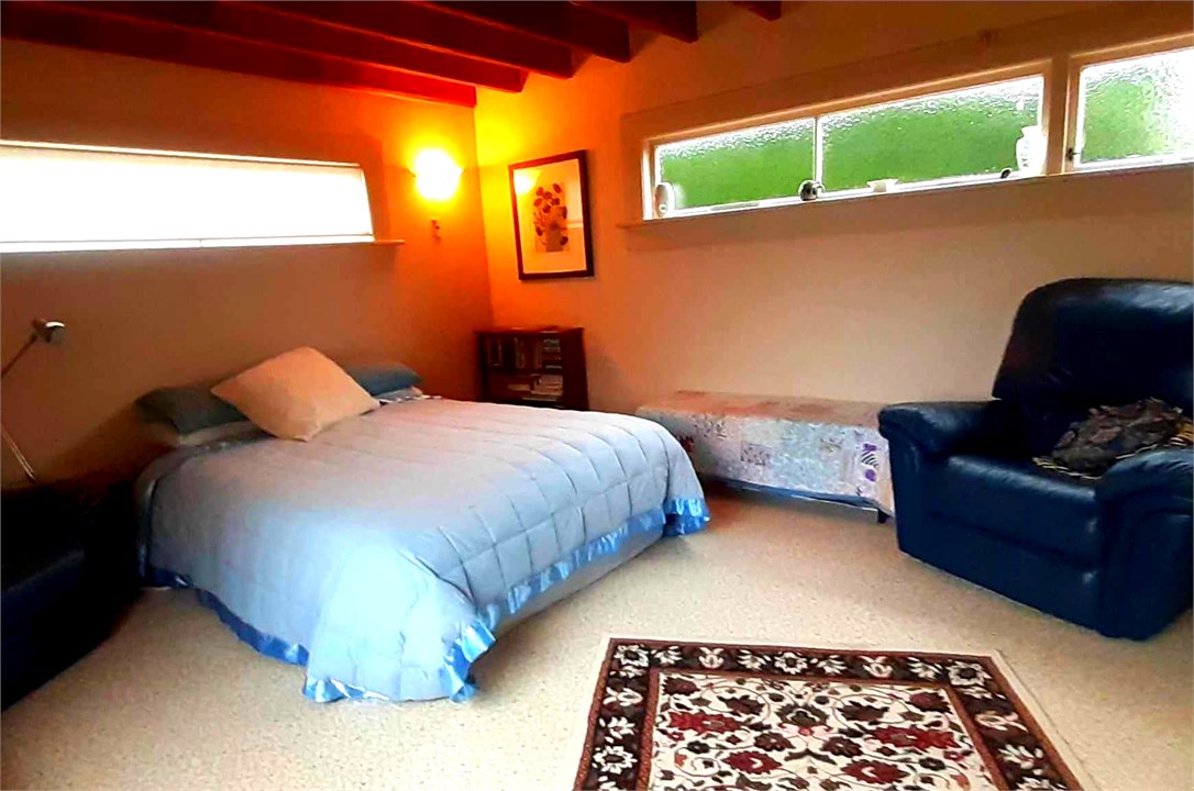 Downstairs Bedroom Queen Bed with children's books