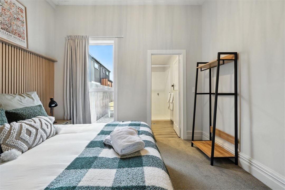 Bedroom 1 with a Queen bed, ensuite and seating ar