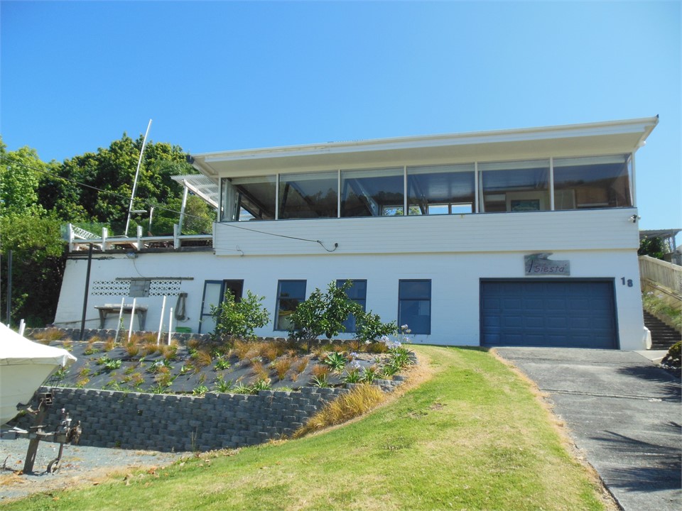 Elevated house from road and main drive