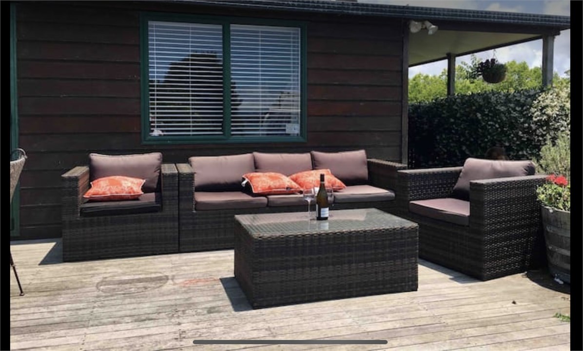 Deck at from of house with outdoor furniture