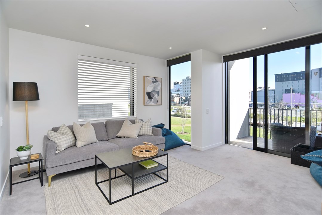 Living room has a TV and seating areas