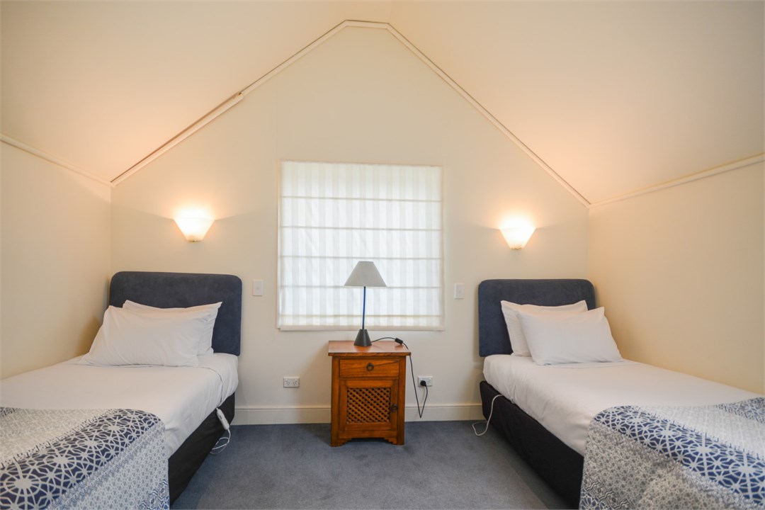 Bedroom 2 has 2 Single beds and a seating area