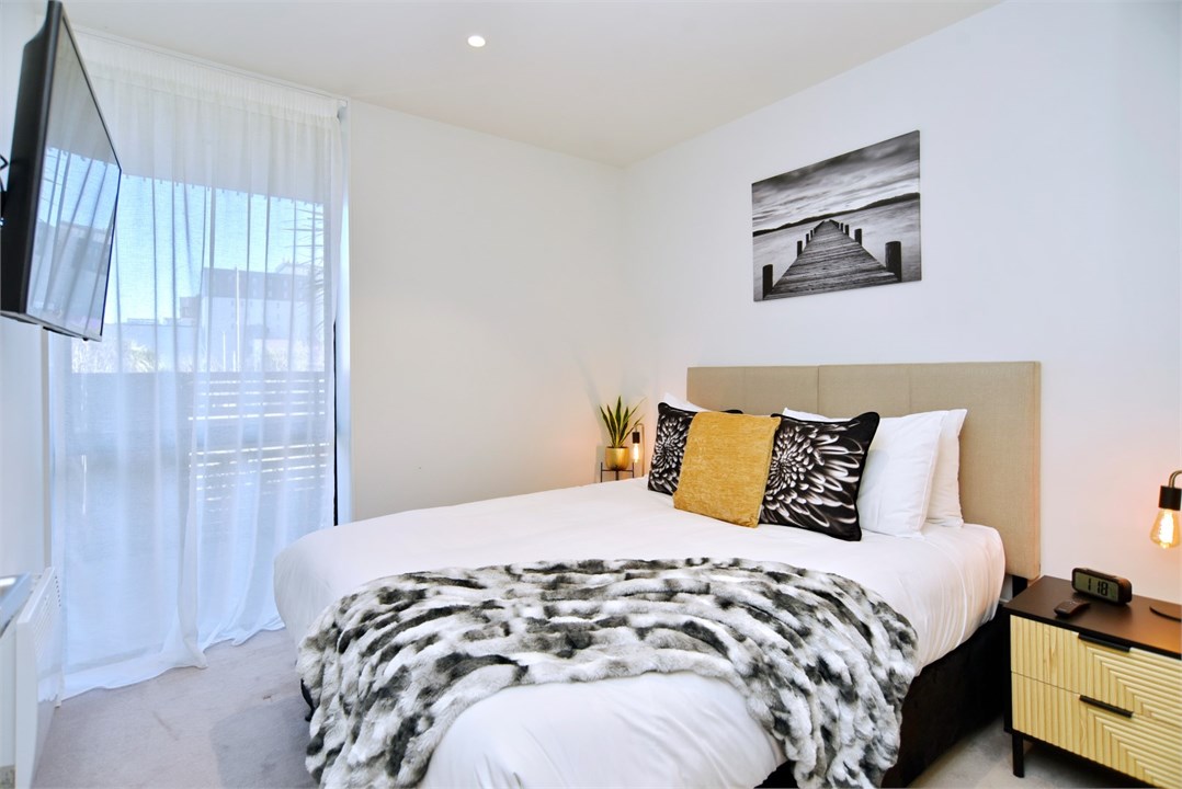 Bedroom 2 has a Queen bed and a TV