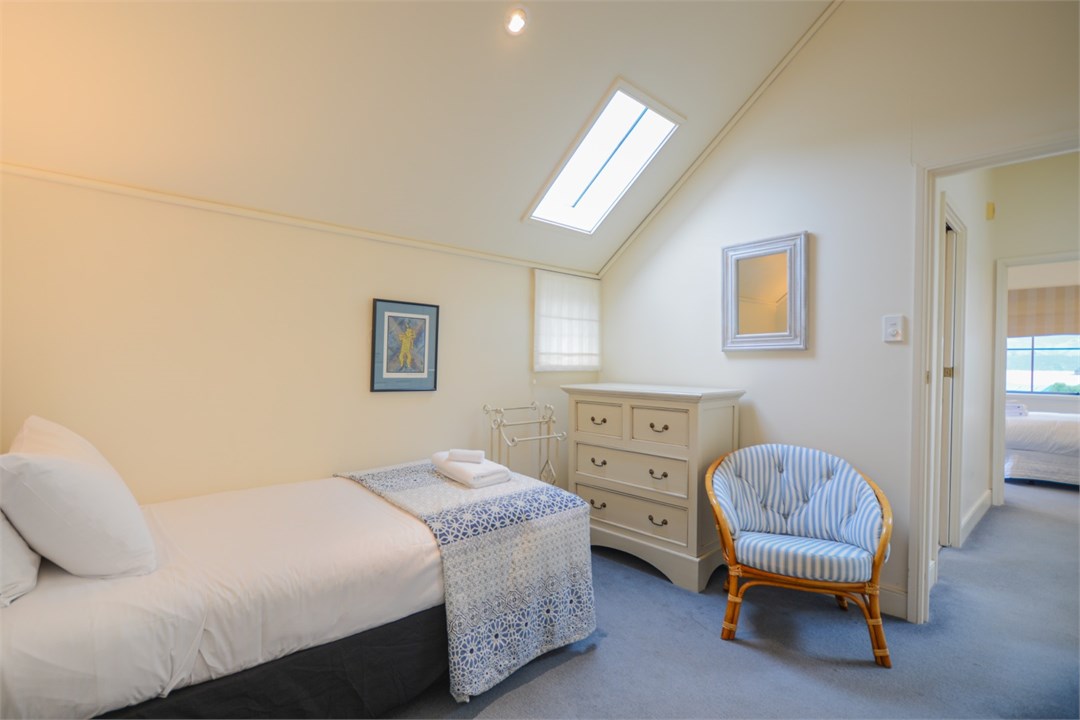 Bedroom 2 has 2 Single beds and a seating area