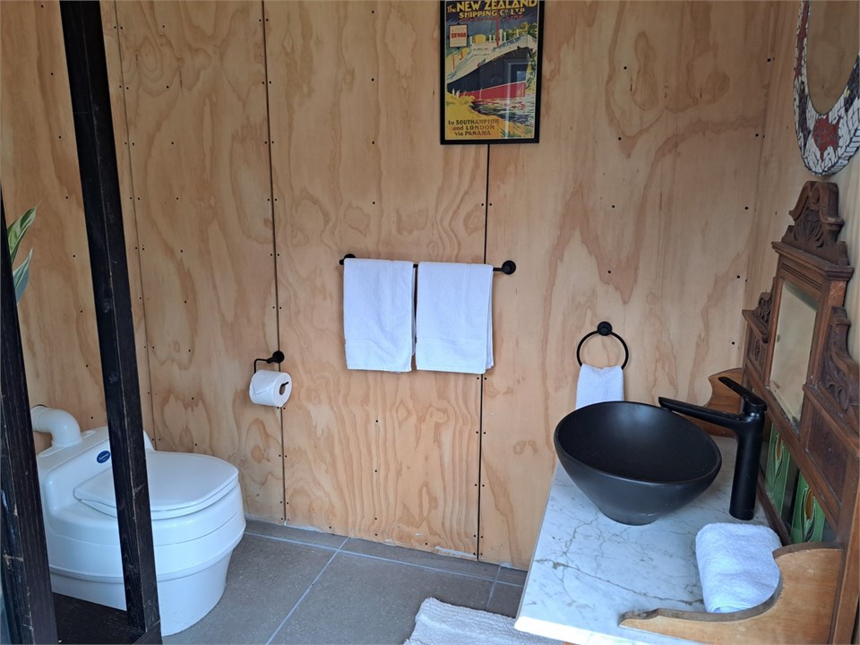 Separate bathroom building with shower and toilet
