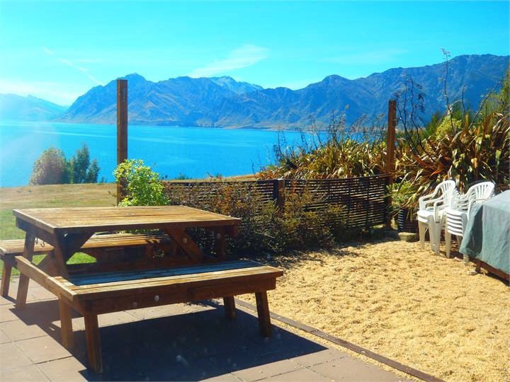 BBQ Area + plenty of seating infront of the lake.