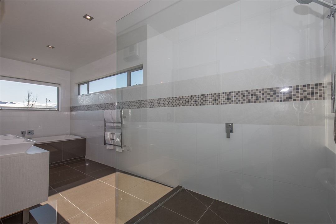 Double basin ensuite with spa bath, shower and toi