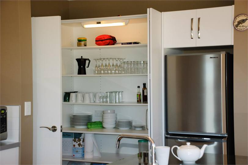 Big pantry with plenty of plates, glasses etc