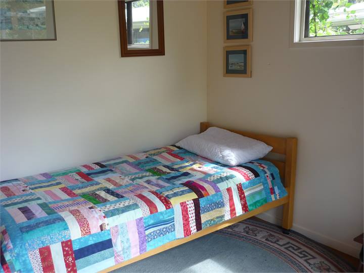 Cabin with two single beds, one a high bunk