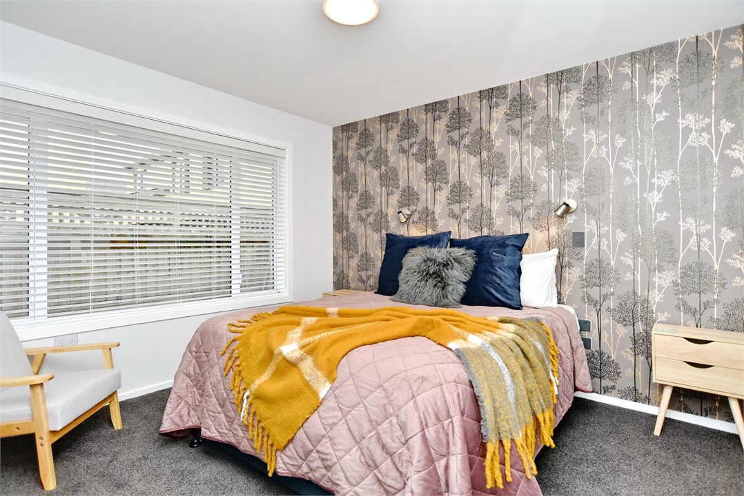 Bedroom 2 has a Queen sized bed and a sitting area