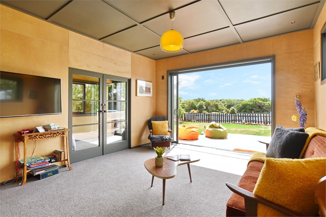 Living room with seating areas and a TV