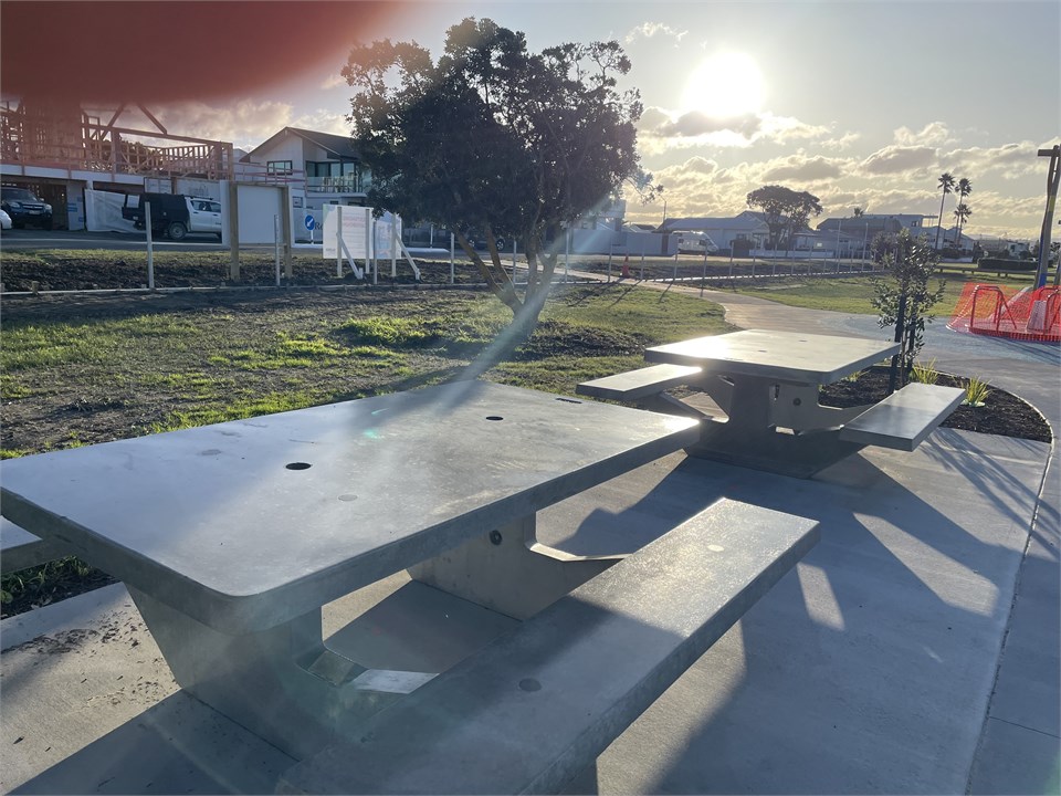 Picnic tables in playground opposite apartment