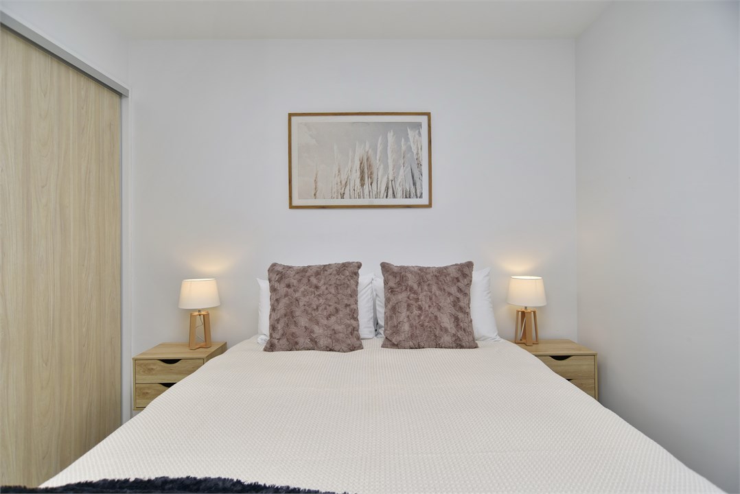 Bedroom 2 has a Queen bed and a seating area